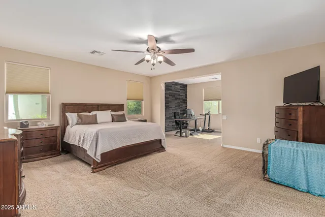 a bedroom with a bed and a chandelier