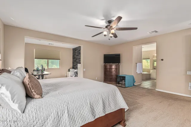 a view of a bedroom with furniture and windows