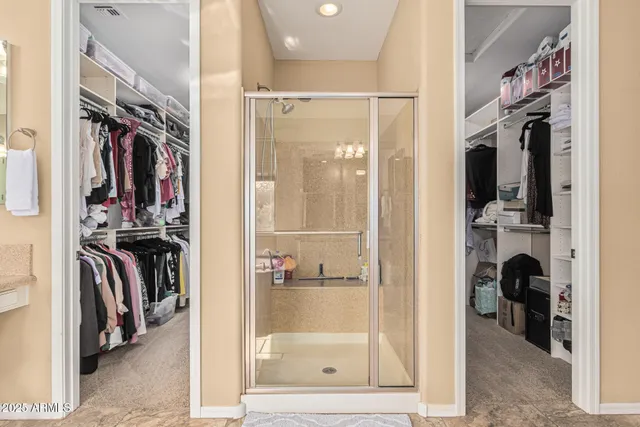 a view of room with flat screen tv and a ceiling fan