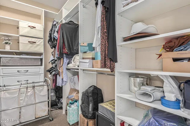 a view of a kitchen with an empty room and a window