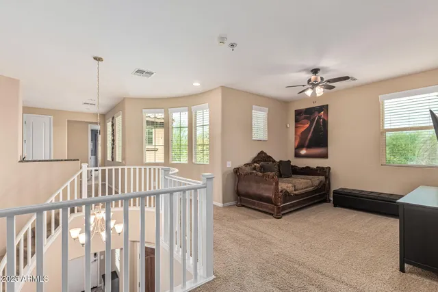 a view of a livingroom with furniture and staircase