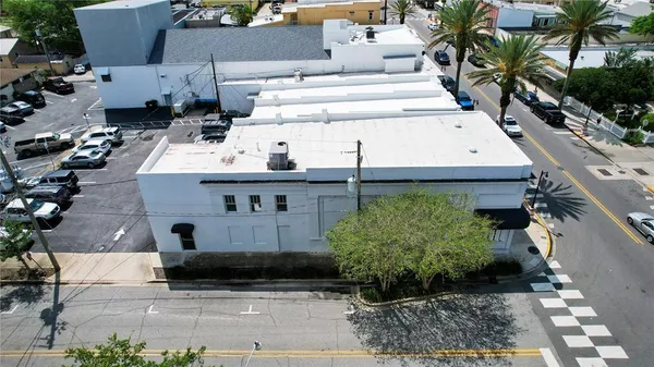 a view of a patio with table and chairs couches with wooden floor and plants