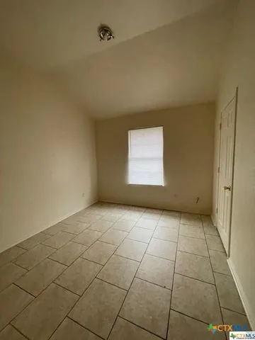 a view of an empty room and a window