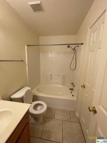 a bathroom with a sink a toilet and bathtub