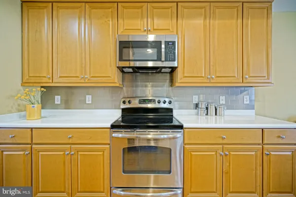 a kitchen with granite countertop cabinets stainless steel appliances and wooden cabinets