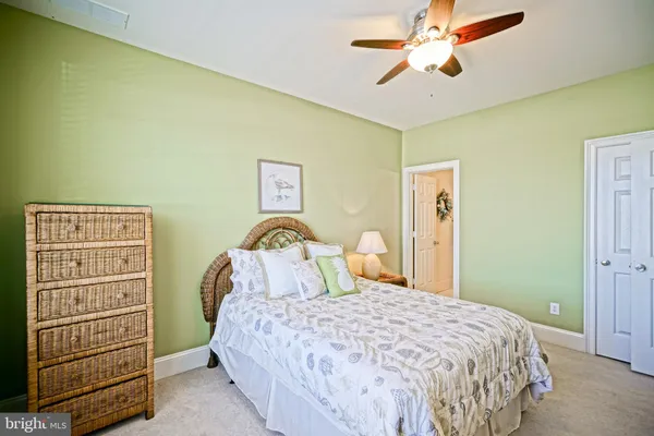 a bedroom with a bed and dresser with mirror