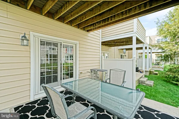 a view of a deck with couches floor to ceiling window with wooden floor