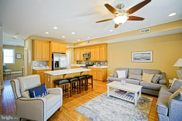 a living room with lots of furniture and a large window