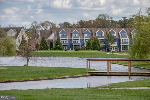 a wooden bench sitting in the middle of a yard