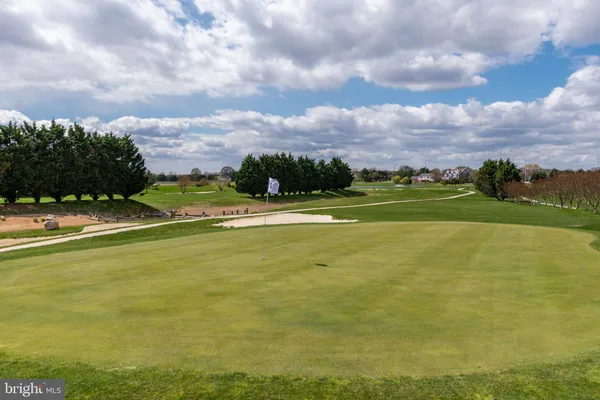 a view of a swimming pool with an outdoor space and seating area