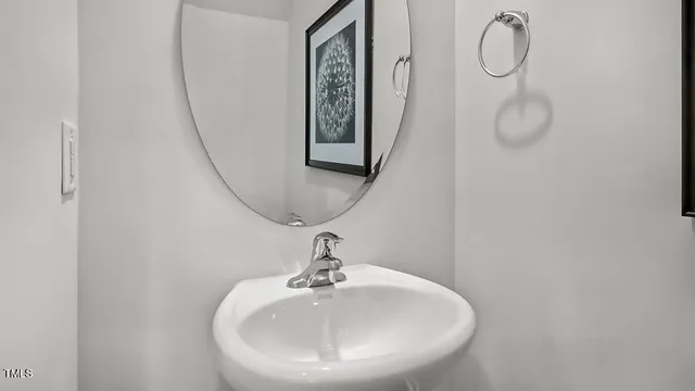 a bathroom with a sink and mirror