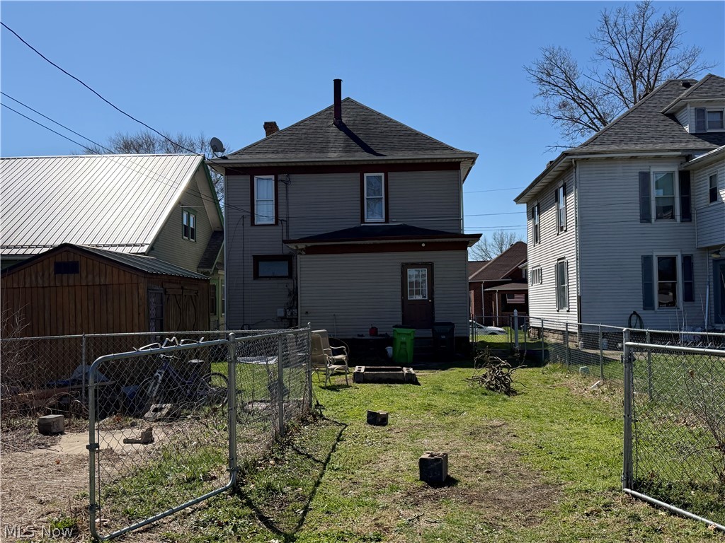 436 Locust Street Coshocton, OH 43812 - Photo 17 of 17 Back of house with a patio area, a shingled roof, and a storage shed