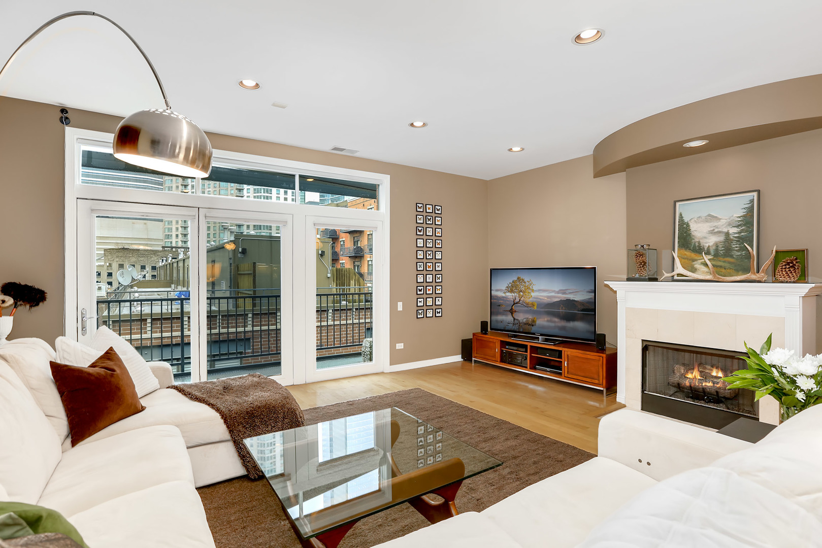 321 North Jefferson Street, Unit 401 Chicago, IL 60661 - Photo 2 of 33 a living room with furniture a flat screen tv and a fireplace