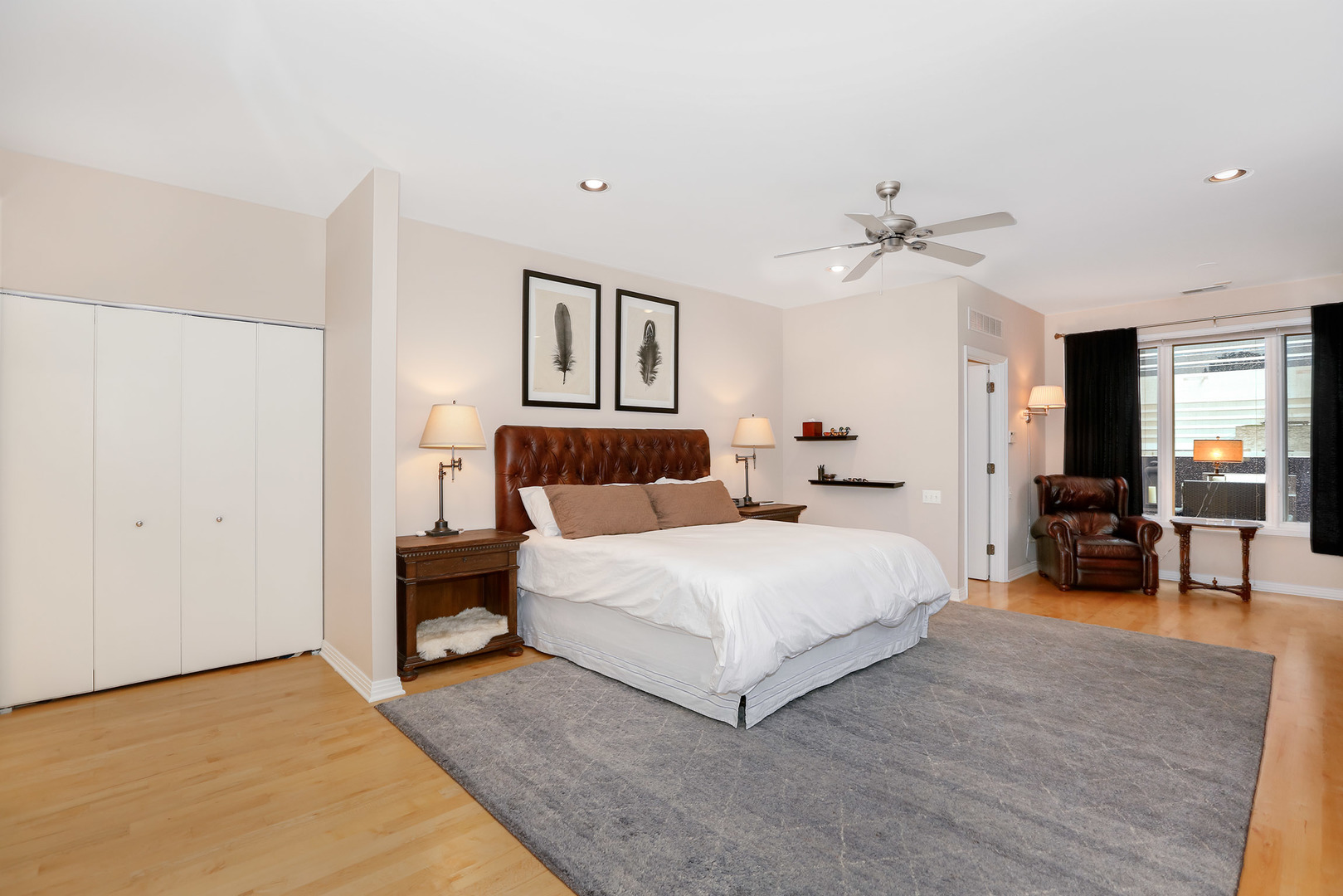 321 North Jefferson Street, Unit 401 Chicago, IL 60661 - Photo 12 of 33 a bedroom with a bed and a chandelier