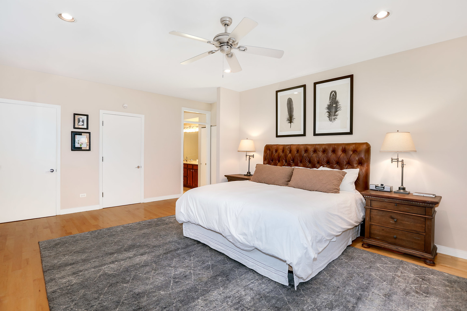 321 North Jefferson Street, Unit 401 Chicago, IL 60661 - Photo 13 of 33 a bedroom with a bed and a chandelier