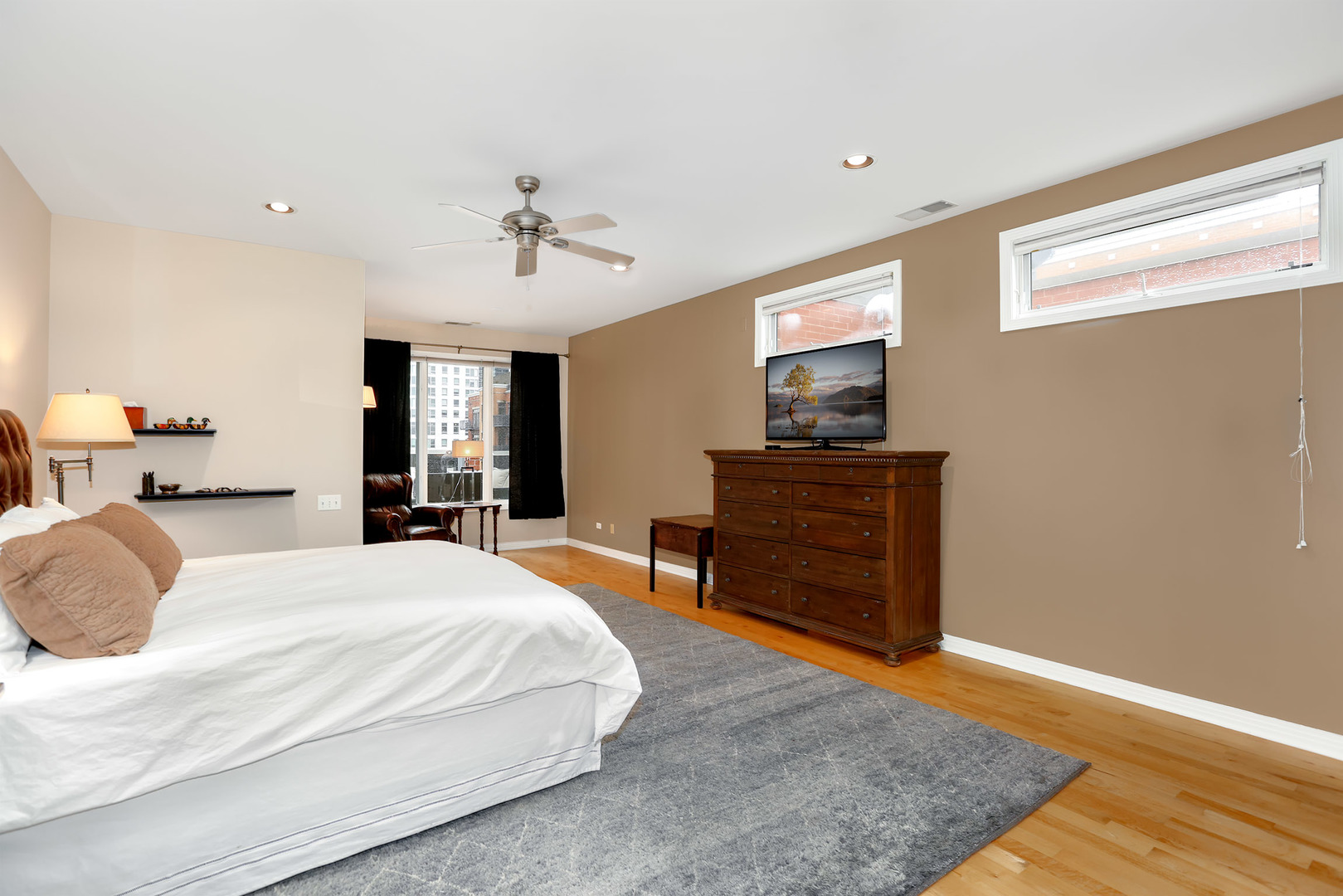 321 North Jefferson Street, Unit 401 Chicago, IL 60661 - Photo 14 of 33 a bedroom with a bed and wooden floor