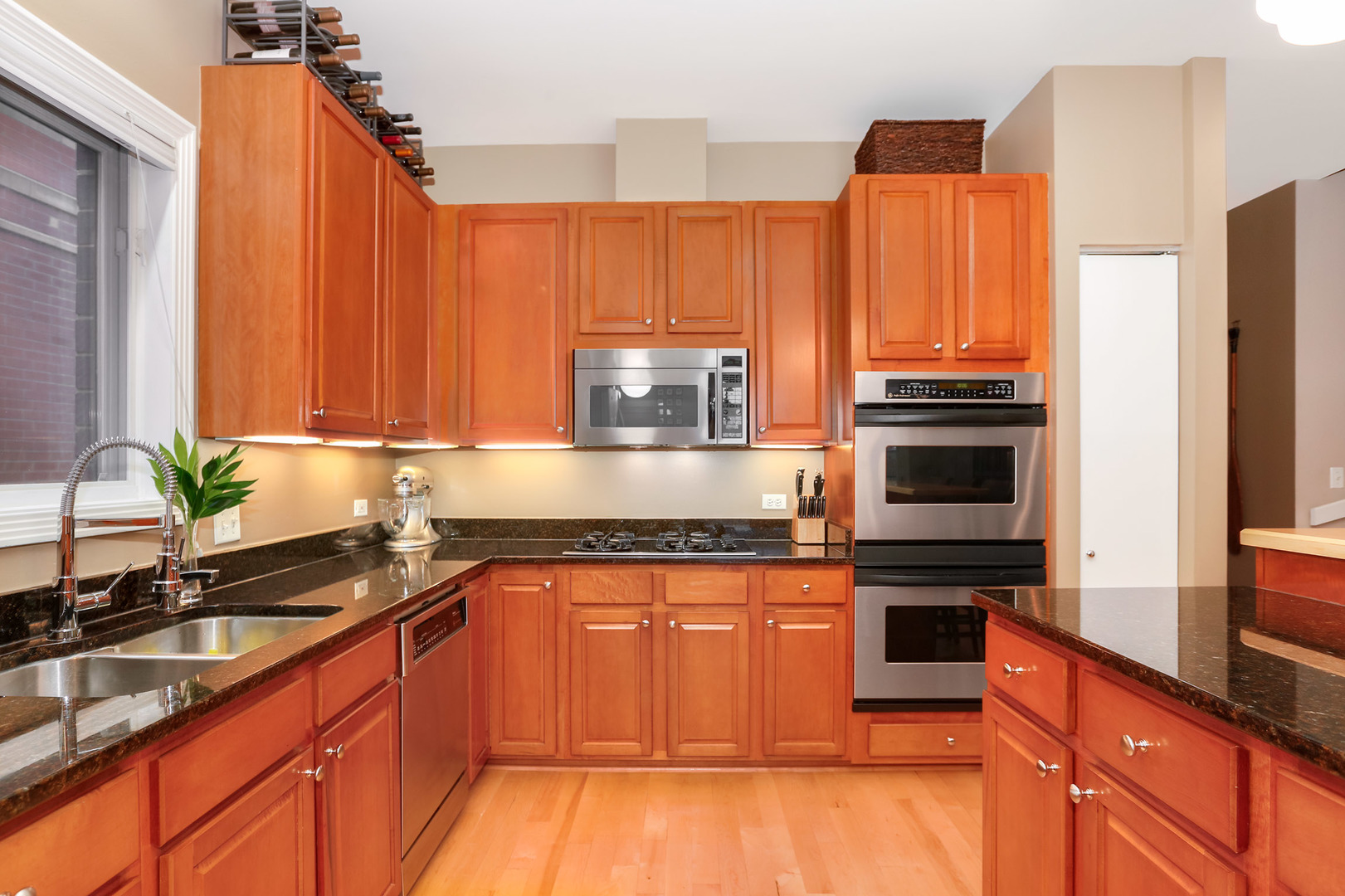 321 North Jefferson Street, Unit 401 Chicago, IL 60661 - Photo 7 of 33 a kitchen with stainless steel appliances granite countertop a stove a sink and a microwave