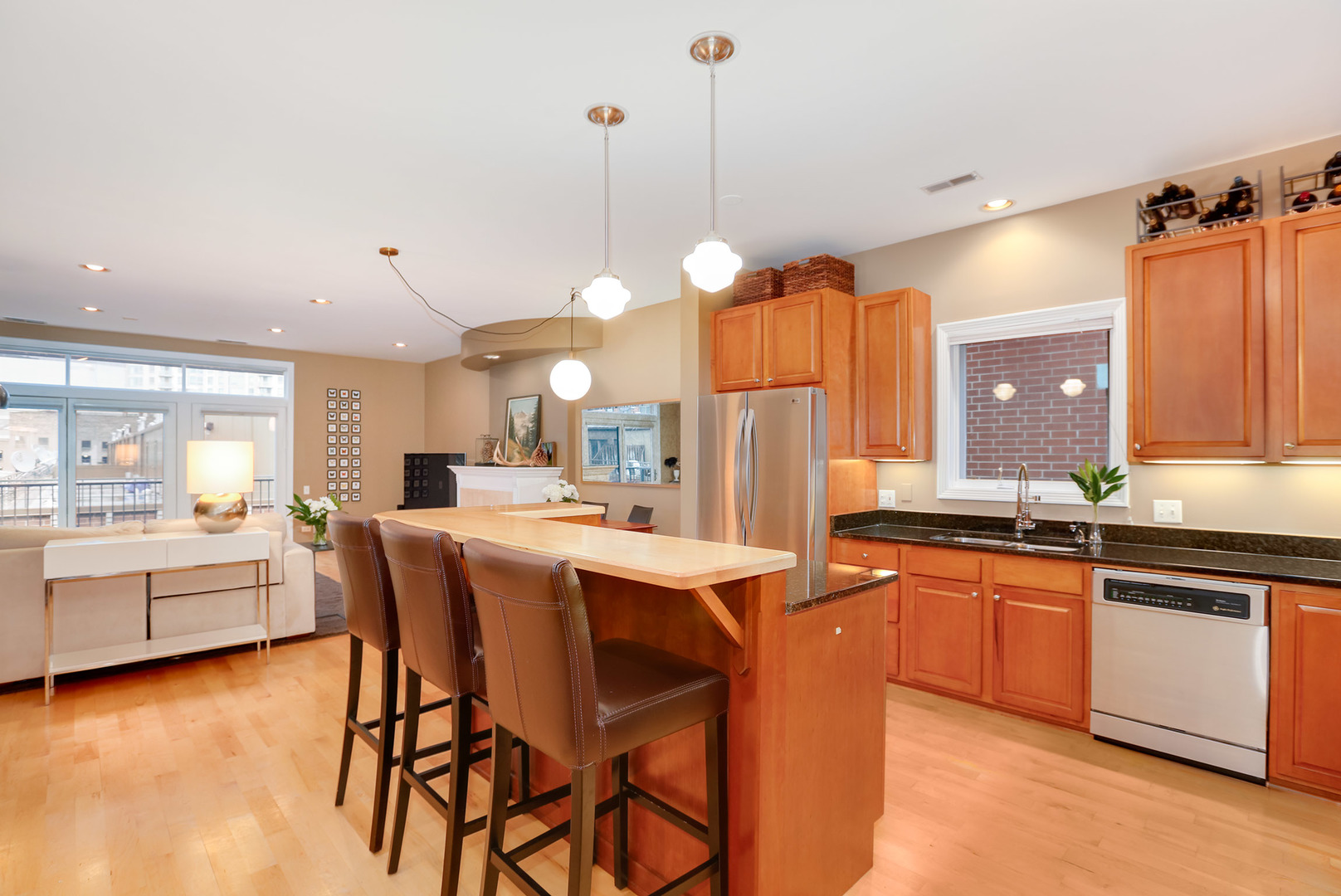 321 North Jefferson Street, Unit 401 Chicago, IL 60661 - Photo 9 of 33 a kitchen with stainless steel appliances granite countertop a kitchen island a stove a sink a dining table and chairs