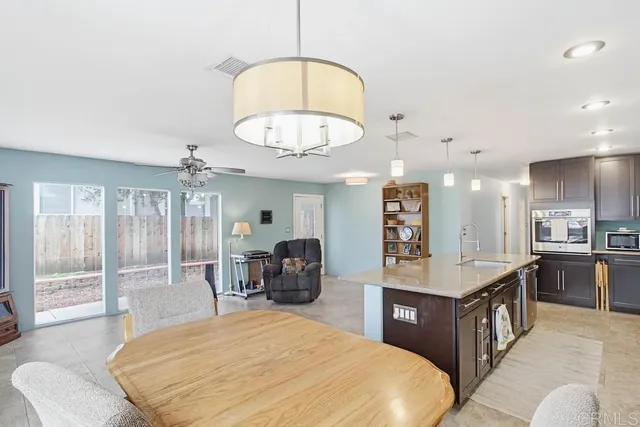 a large room with kitchen island a large island in it