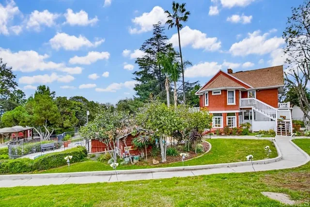 a front view of a house with a yard table and chairs