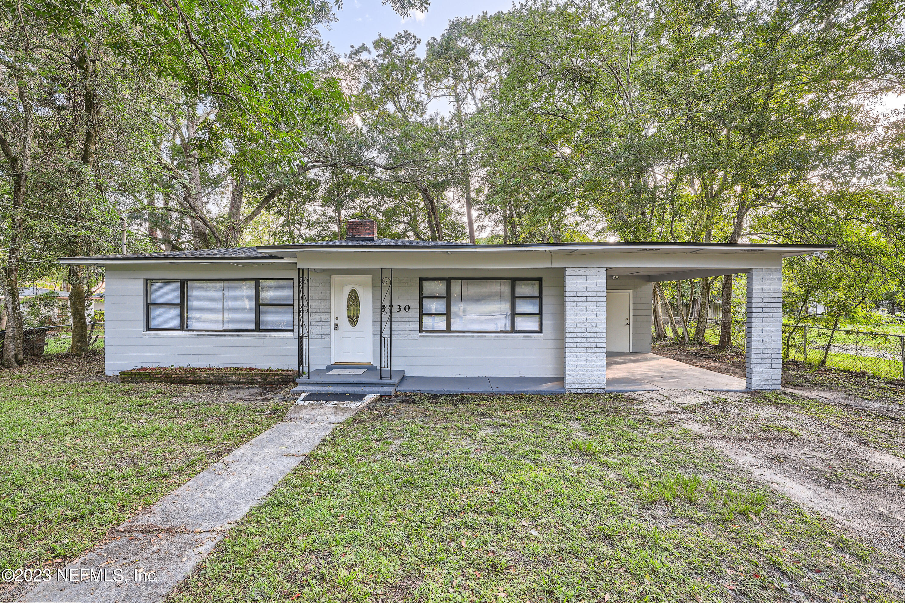 5730 Moncrief Road Jacksonville, FL 32209 - Photo 1 of 37 front view of a house with a yard