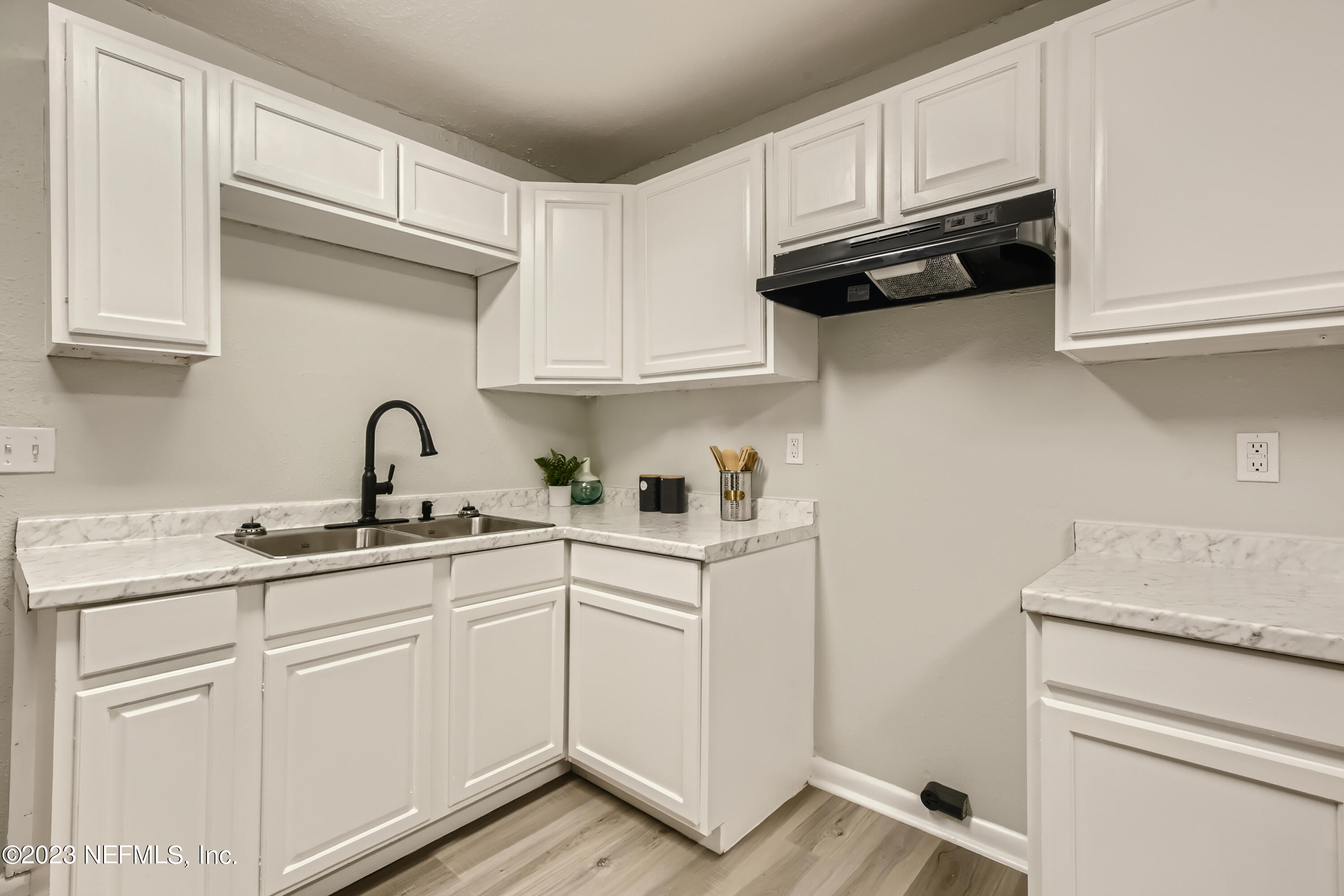 5730 Moncrief Road Jacksonville, FL 32209 - Photo 11 of 37 a kitchen with white cabinets and white appliances