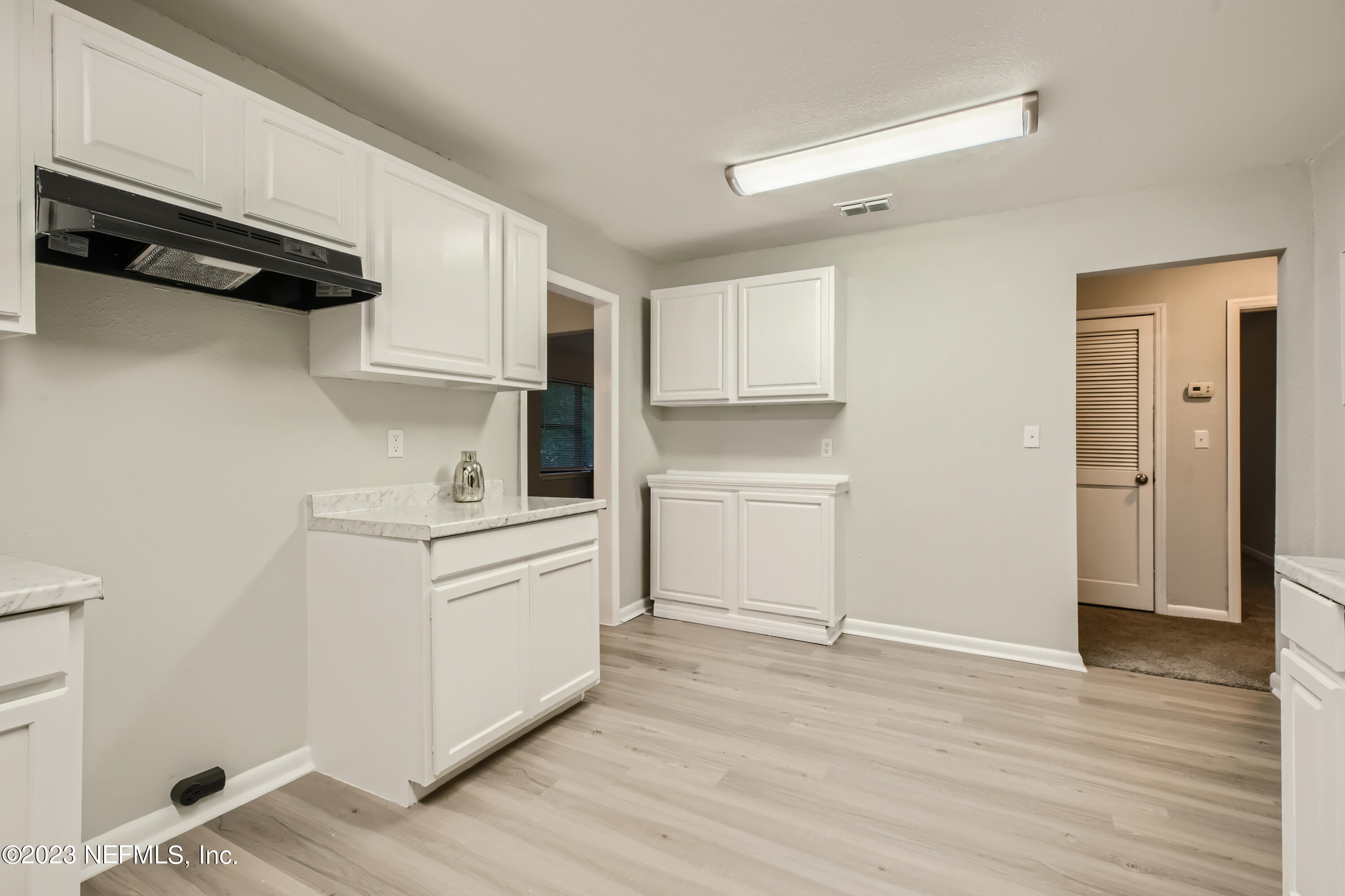 5730 Moncrief Road Jacksonville, FL 32209 - Photo 12 of 37 a kitchen with white cabinets and white appliances