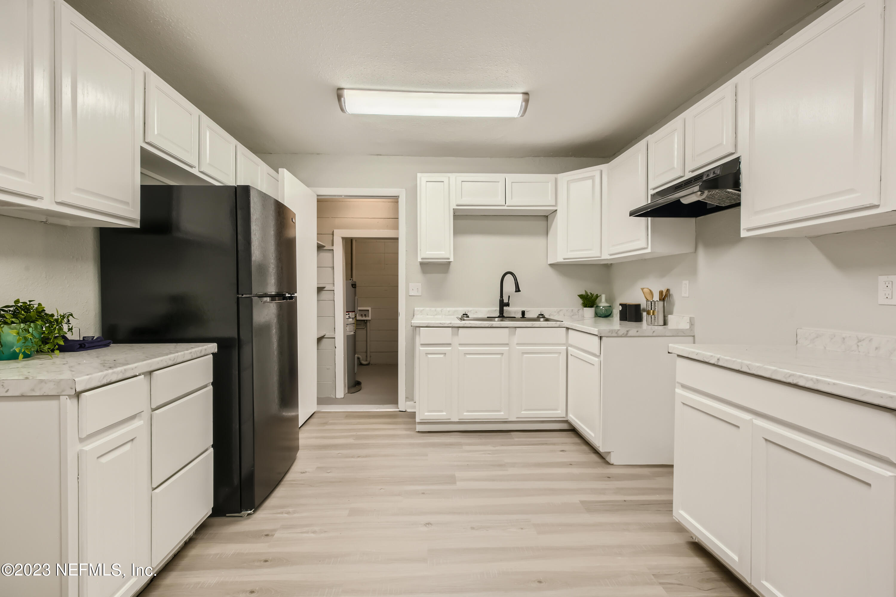 5730 Moncrief Road Jacksonville, FL 32209 - Photo 14 of 37 a kitchen with white cabinets and white appliances