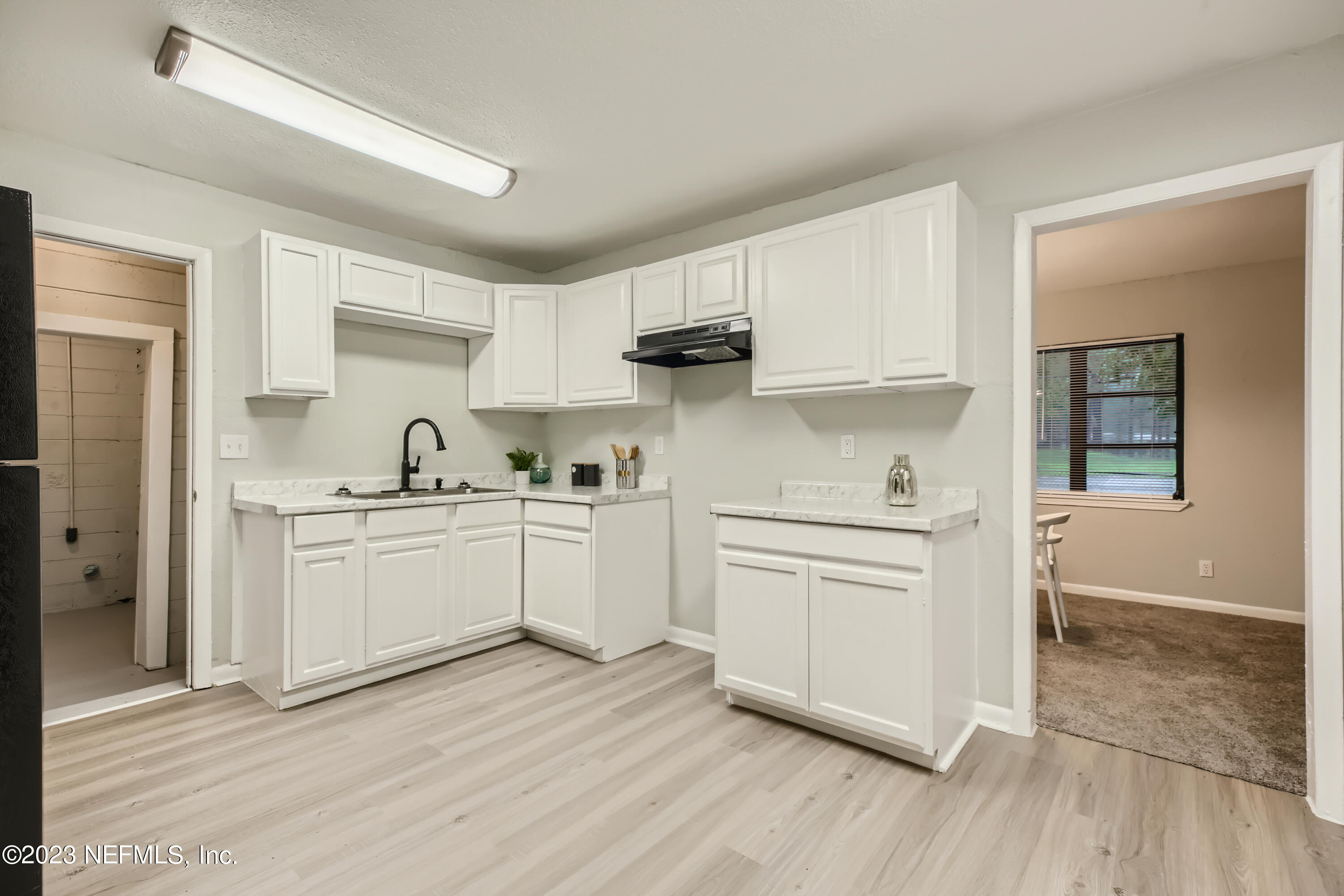 5730 Moncrief Road Jacksonville, FL 32209 - Photo 15 of 37 a kitchen with white cabinets and white appliances