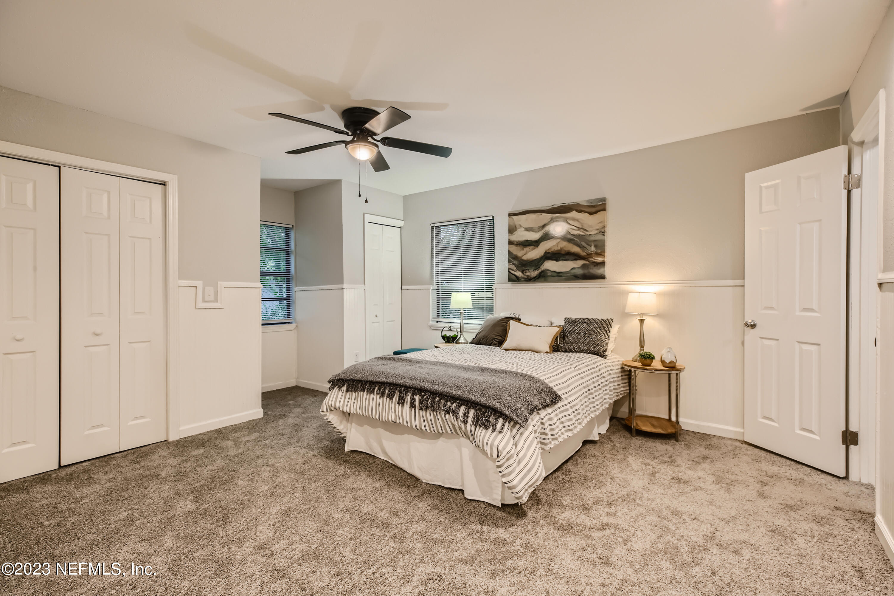 5730 Moncrief Road Jacksonville, FL 32209 - Photo 17 of 37 a spacious bedroom with a bed and a painting on the wall
