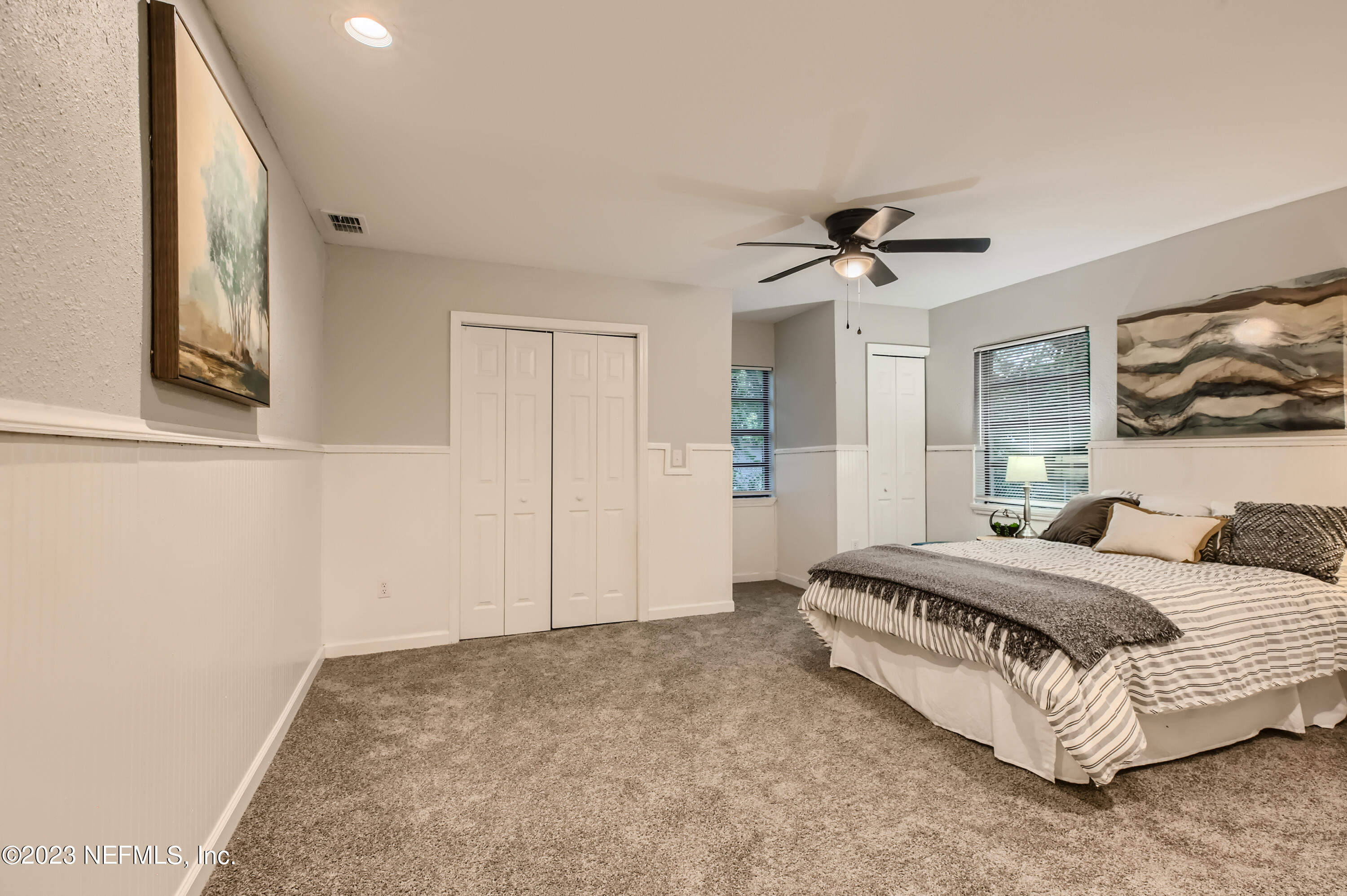 5730 Moncrief Road Jacksonville, FL 32209 - Photo 18 of 37 a spacious bedroom with a bed and a chandelier