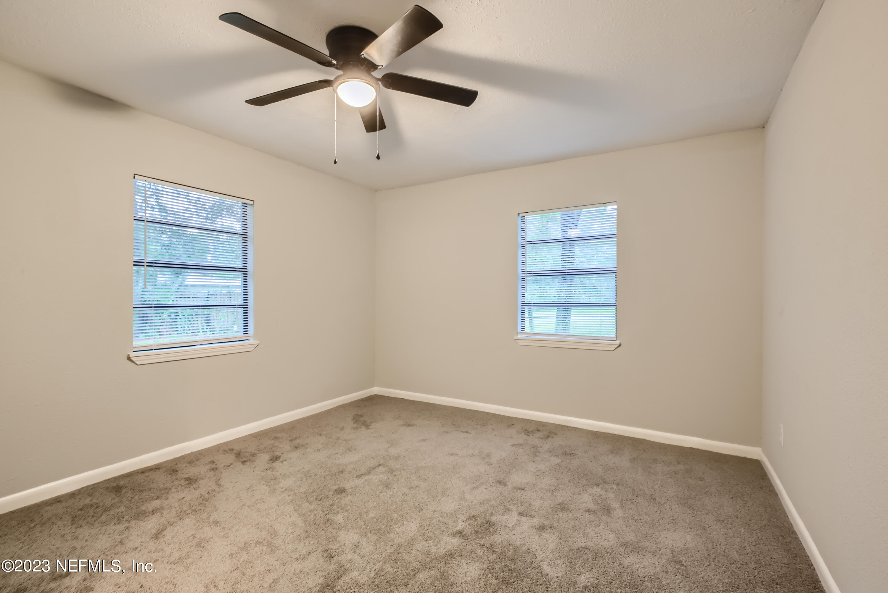 5730 Moncrief Road Jacksonville, FL 32209 - Photo 24 of 37 en empty room with windows and ceiling fan