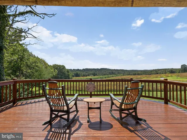 a view of a balcony with wooden floor and outdoor seating