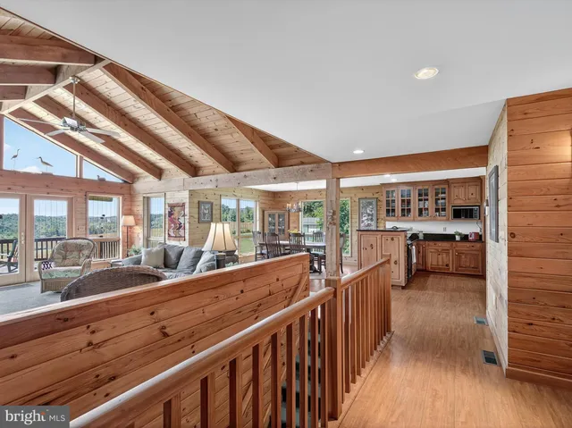 a dining room with furniture a chandelier and wooden floor