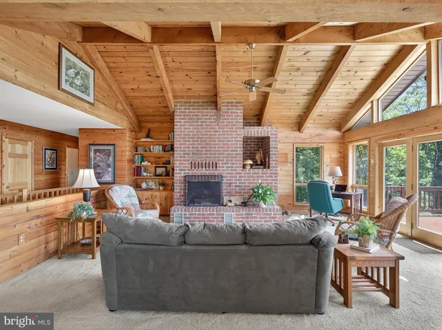 a living room with furniture and large windows