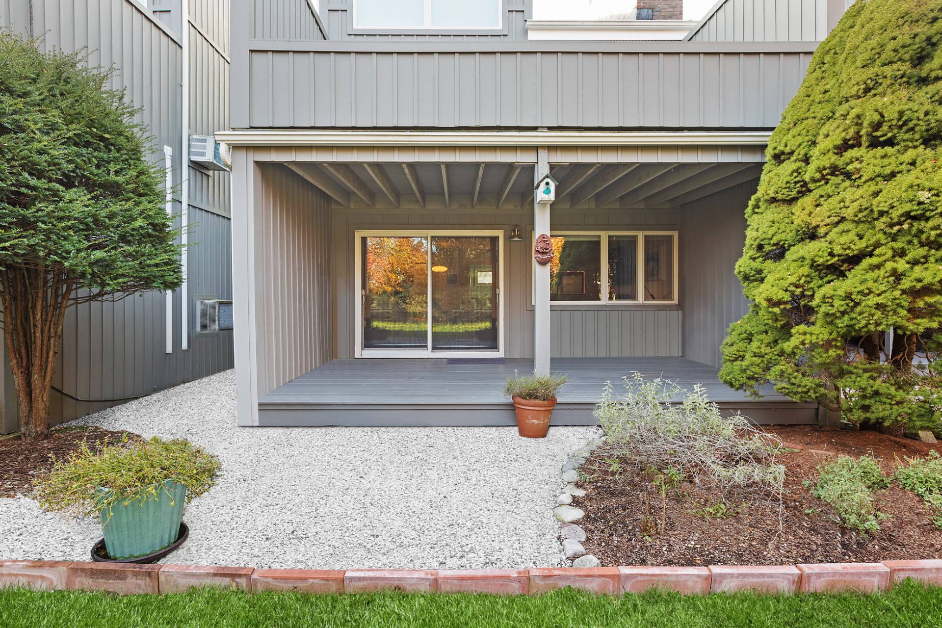 514 Pantigo Road, Unit 7 East Hampton, NY 11937 - Photo 13 of 14 a front view of a house with a yard and potted plants