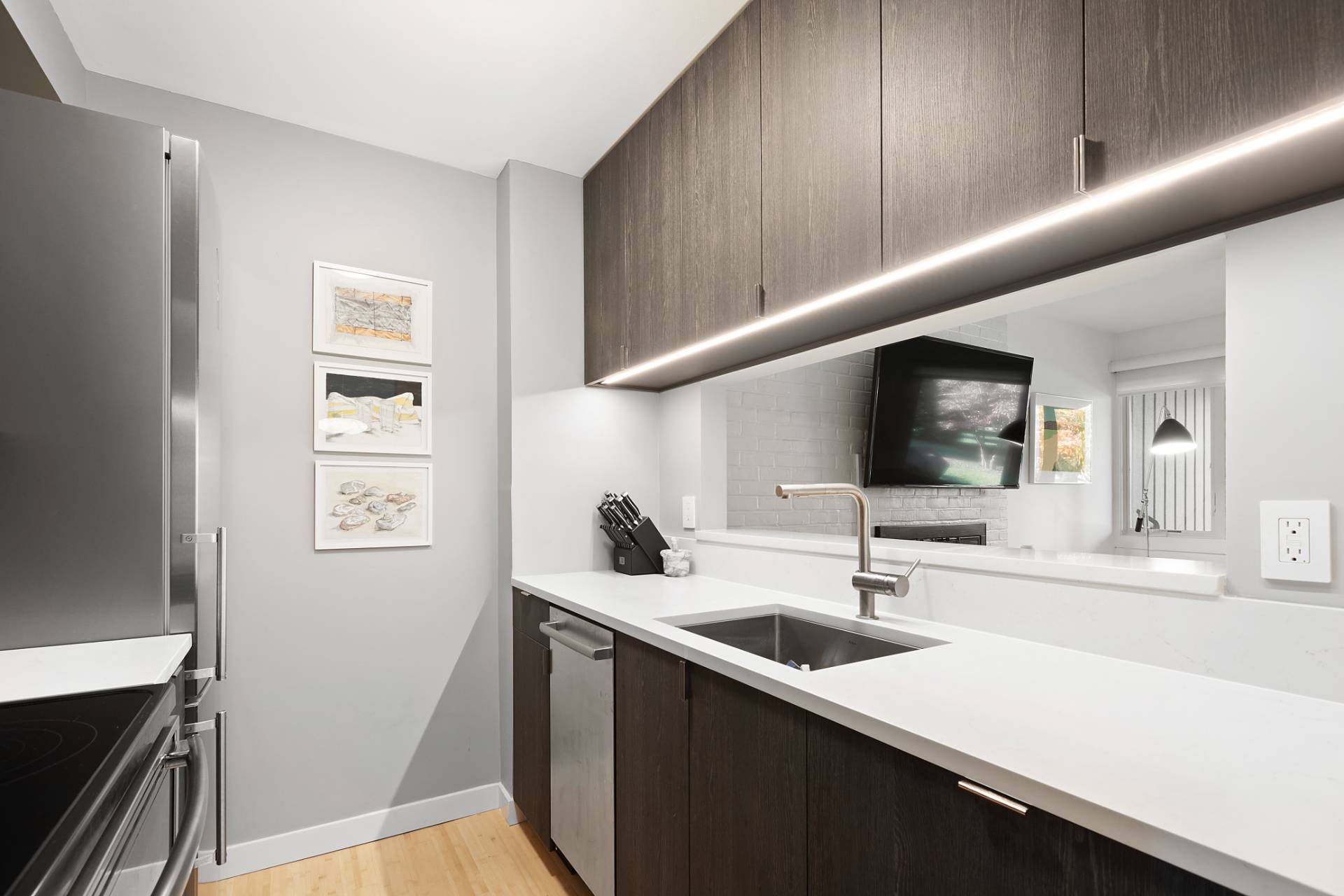 514 Pantigo Road, Unit 7 East Hampton, NY 11937 - Photo 6 of 14 a kitchen with a sink and a refrigerator