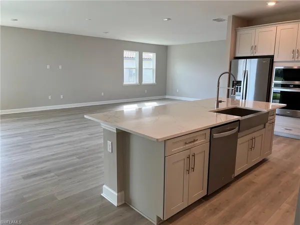 a large kitchen with stainless steel appliances granite countertop a large counter top and a stove top oven