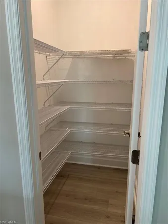 a kitchen with a sink cabinets and wooden floor
