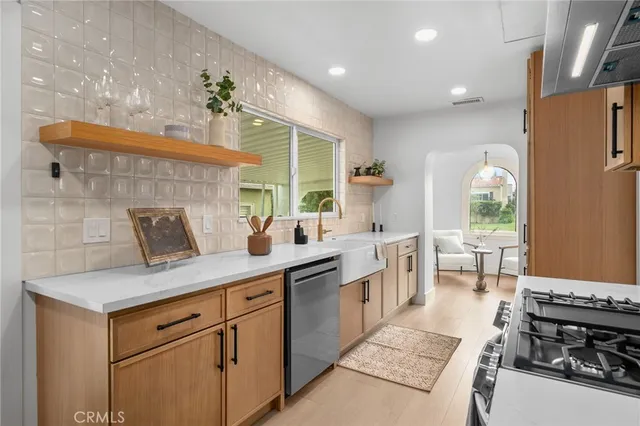 a kitchen with a sink and wooden cabinets