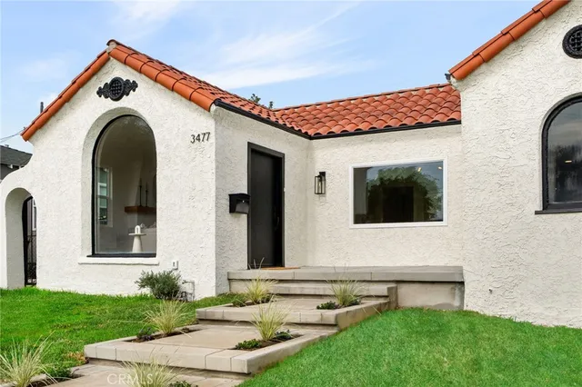 a front view of a house with garden