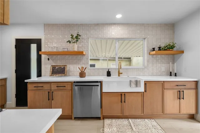 a kitchen with a sink stove and cabinets