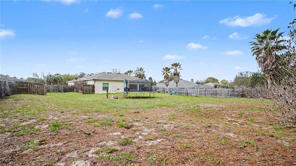 5211 Southwest 103rd Loop Ocala, FL 34476 - Photo 17 of 18 a view of a big house with a big yard