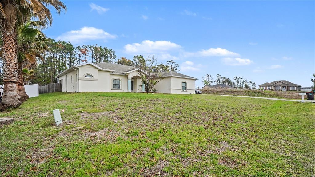 5211 Southwest 103rd Loop Ocala, FL 34476 - Photo 18 of 18 a view of a house with a yard
