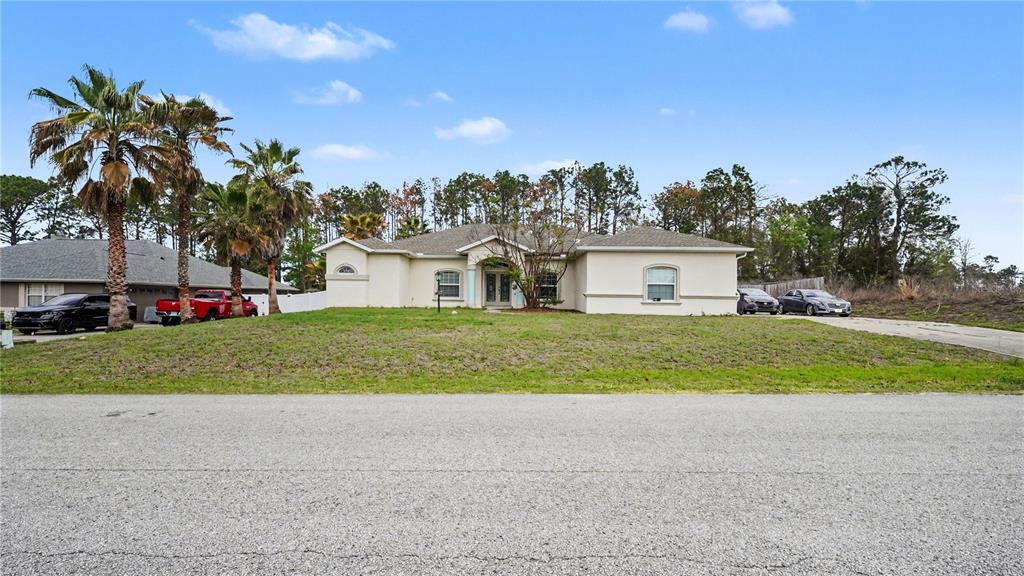 5211 Southwest 103rd Loop Ocala, FL 34476 - Photo 2 of 18 a front view of house with yard and green space