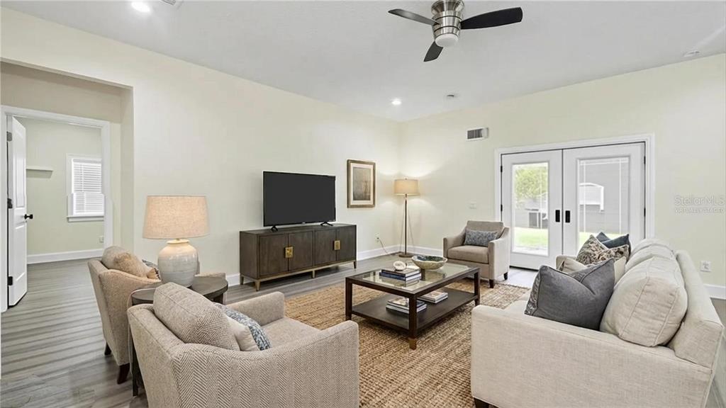 5211 Southwest 103rd Loop Ocala, FL 34476 - Photo 4 of 18 a living room with furniture a flat screen tv and a window