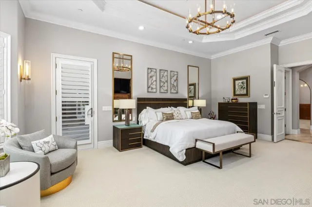 a spacious bedroom with a bed and a television