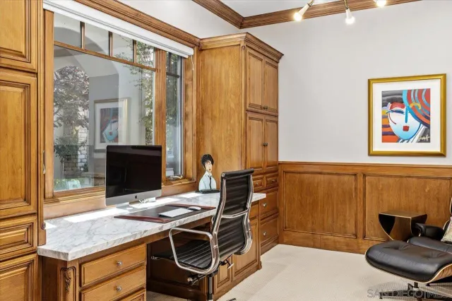 a living room with furniture a flat screen tv and floor to ceiling window