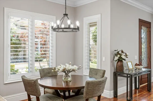 a spacious bedroom with a bed and a chandelier