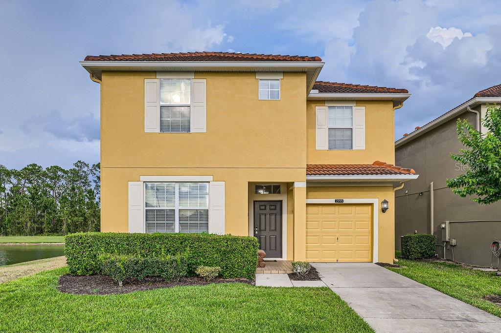 2999 Buccaneer Palm Road Kissimmee, FL 34747 - Photo 1 of 49 front view of a house with a yard and potted plants